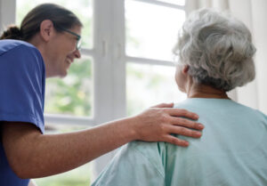 Interdisciplinary hospice care nurse meeting with the patient in Houston home to provide comfort-focused end-of-life support